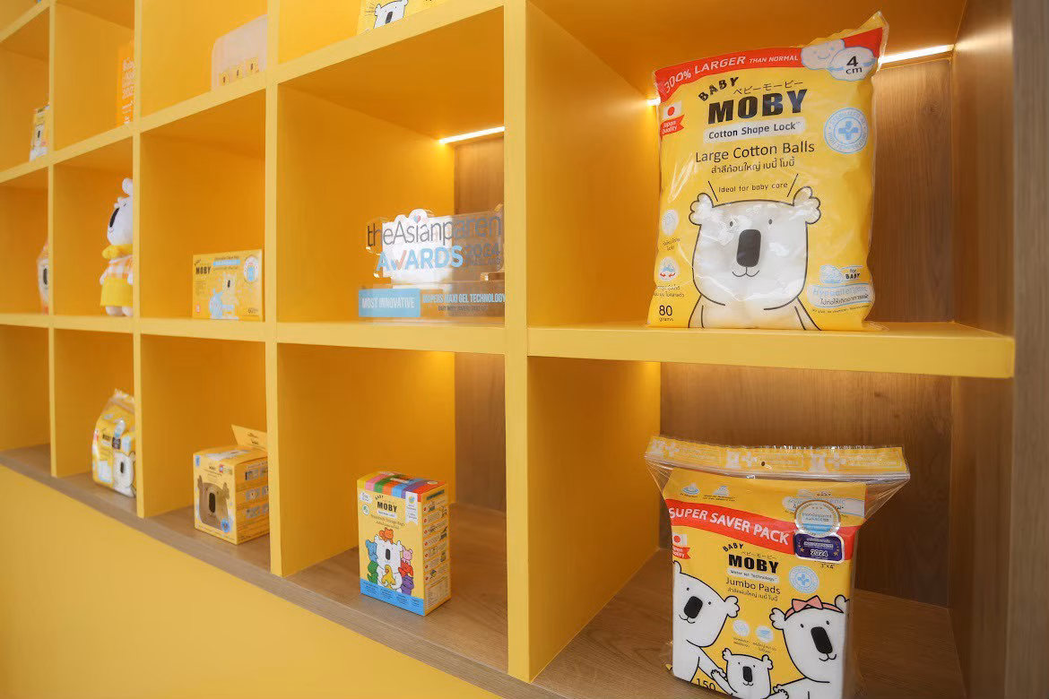 Baby Moby product shelf display featuring cotton balls and jumbo pads